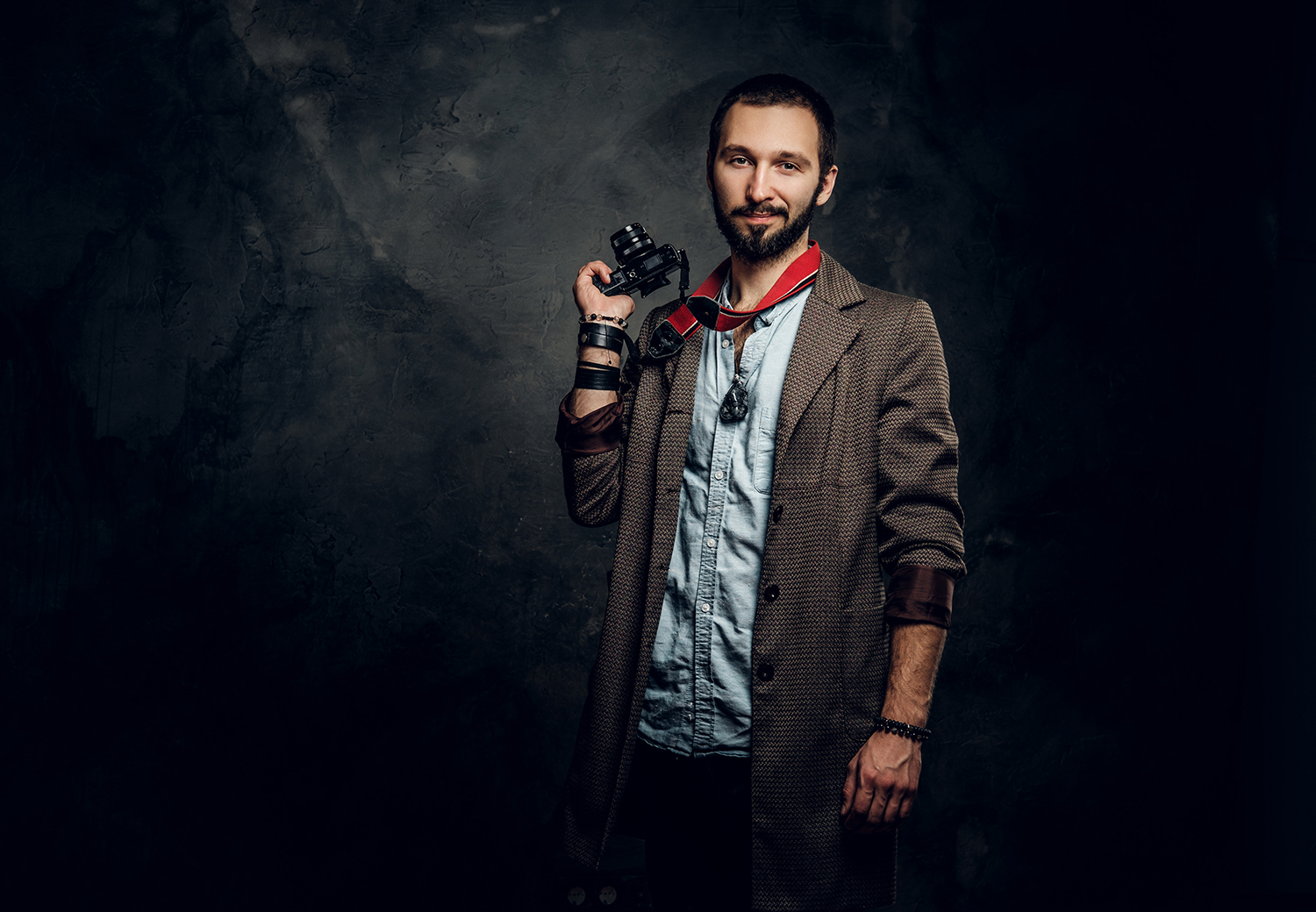 Man is posing for photographer with photo camera